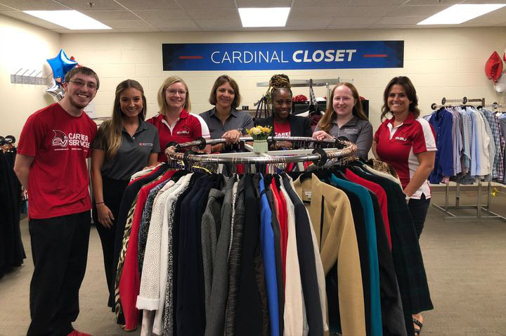 people around rack of clothing